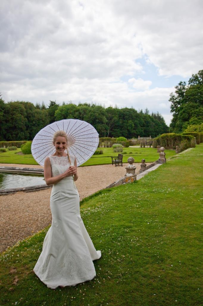 wedding photographer shows bride Rhinefield House