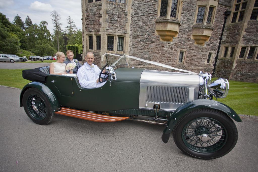 Vintage wedding car for the bride and groom at Rhinefield House by wedding photographer Henry Szwinto